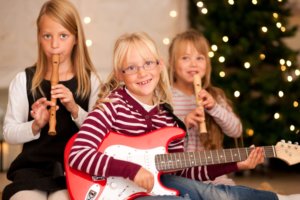 Young children with guitars and flutes
