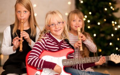 Young children with guitars and flutes